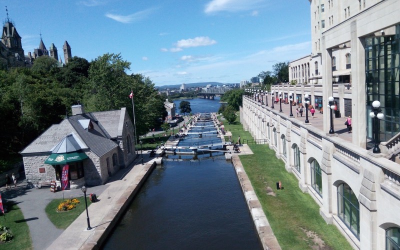 The Rideau Canal locks in Ottawa in summer with Parliament Hill in the distance